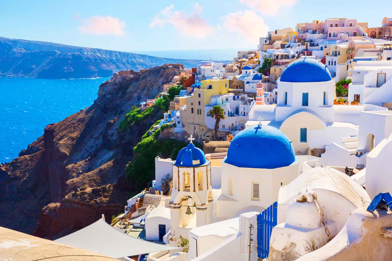 blue church rooftops on santorini island in greece