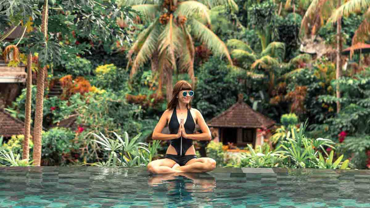 Woman in prayer position at a Bali Yoga Retreat