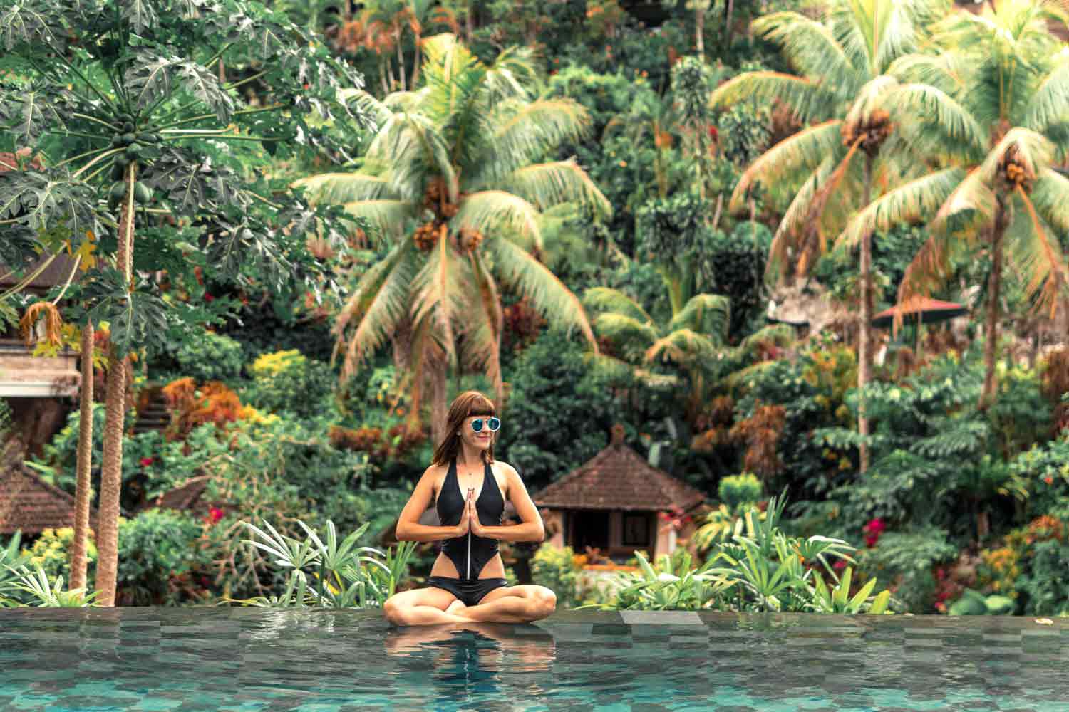 woman by the pool on a yoga teacher training retreat in bali
