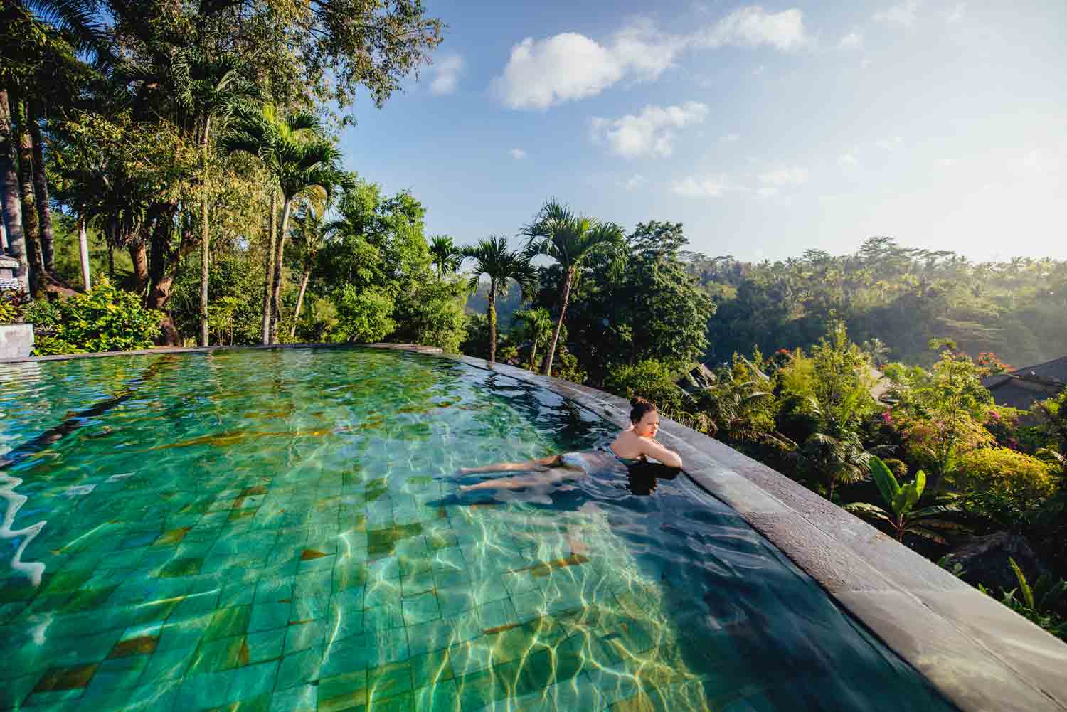 Relaxing in a uxury infinity pool at a retreat overlooking the jungle